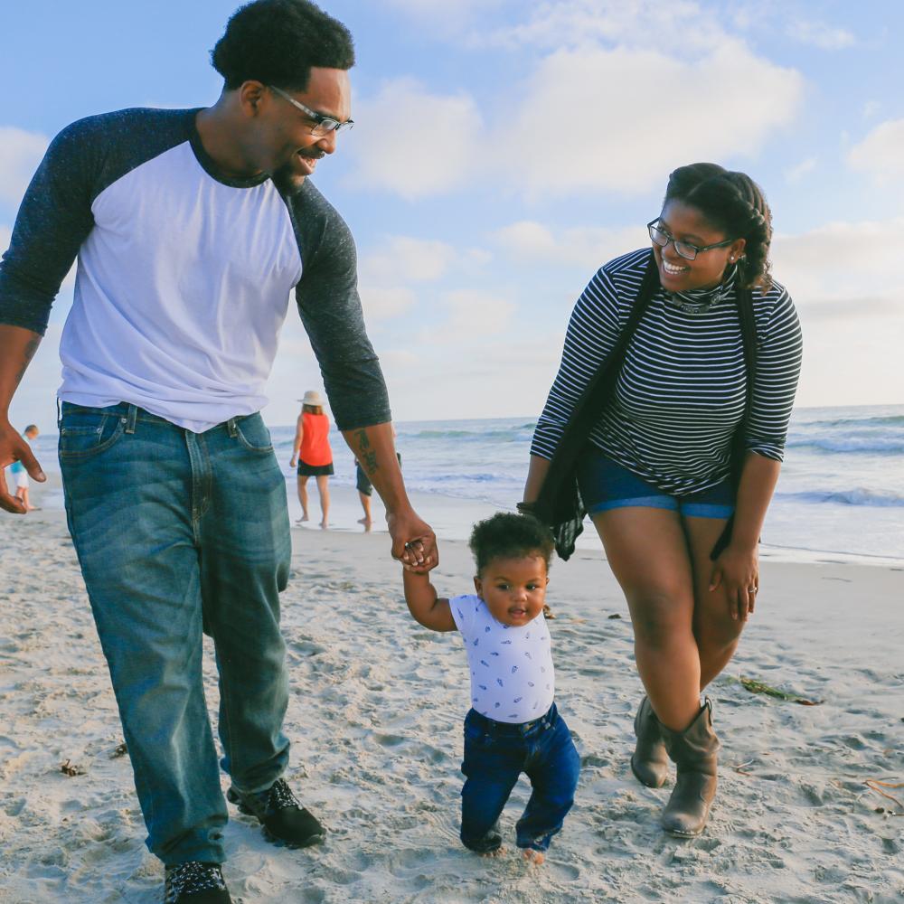 A family walking along the beach