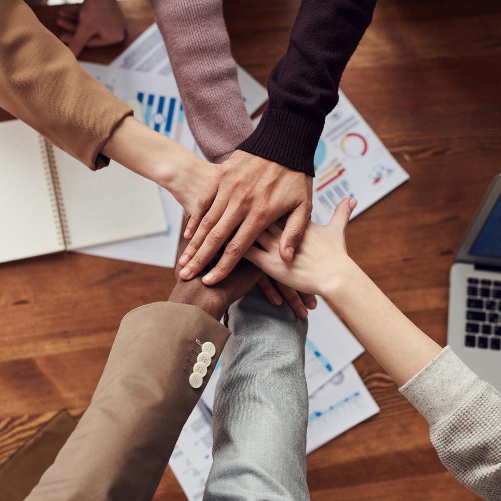 A group of hands stacks on top of another