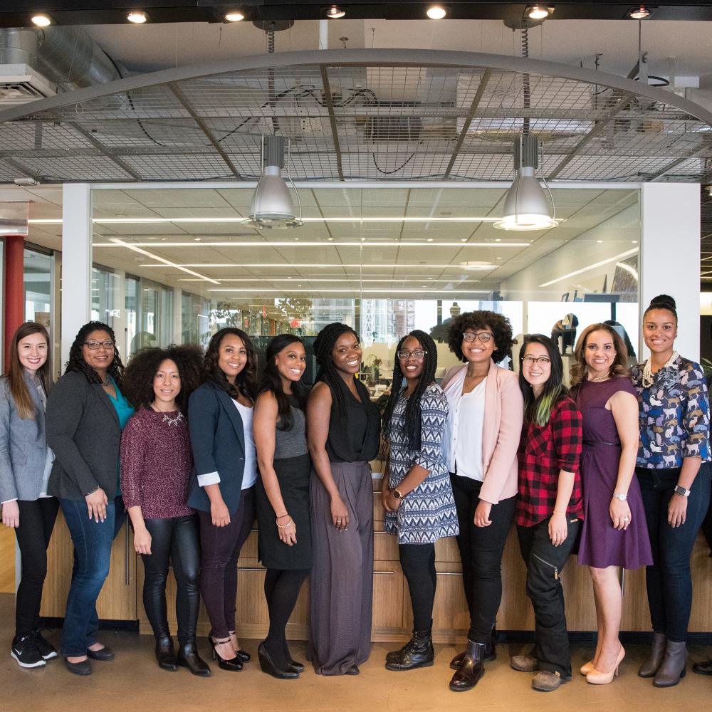 A work force of woman lined up in front of their business