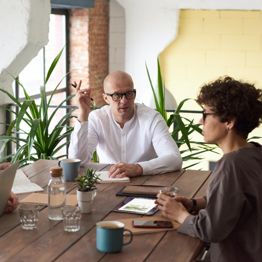 A work meeting with a wooden table