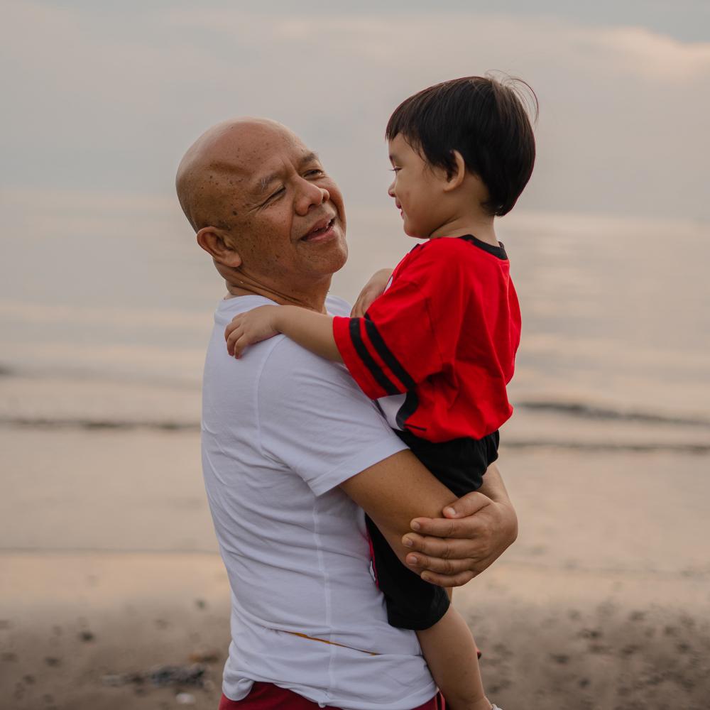 A grandfather holding his grandchild